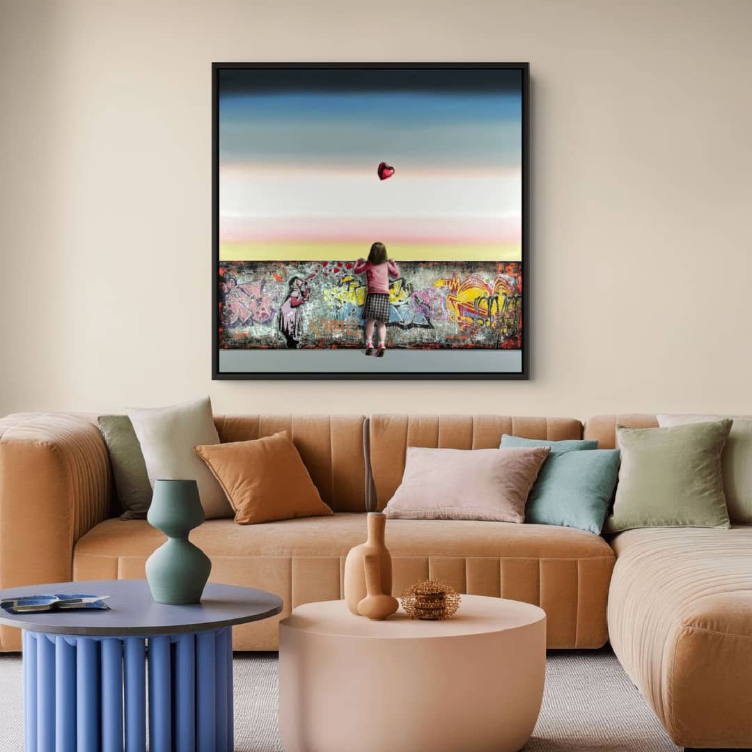 UK artist Steve Johnston painting ~ 'Blowin' in the Wind' - exclusively in Australia at Curate Art & Design in Daylesford, Melbourne, Australia.

A child stands in front of a graffiti-covered wall, facing a large canvas painting of a woman with a red heart floating above her, set against a sunset sky gradient.